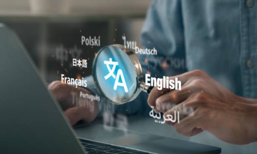 Man hand using magnifying glass to translation of foreign languages on website.Symbol of translation.Ai translator.Worldwide language conversation.