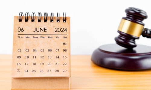 Desk calendar for June 2024 and judge's gavel on the worktable.